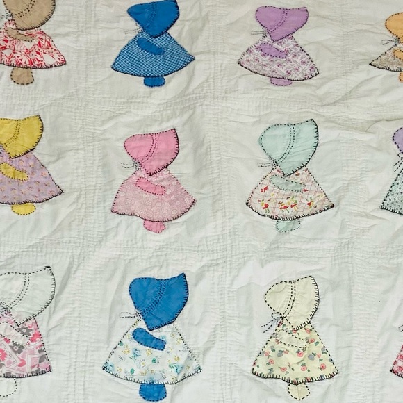 Vintage handmade Holly Hobby appliqué quilt with pink backing and border.